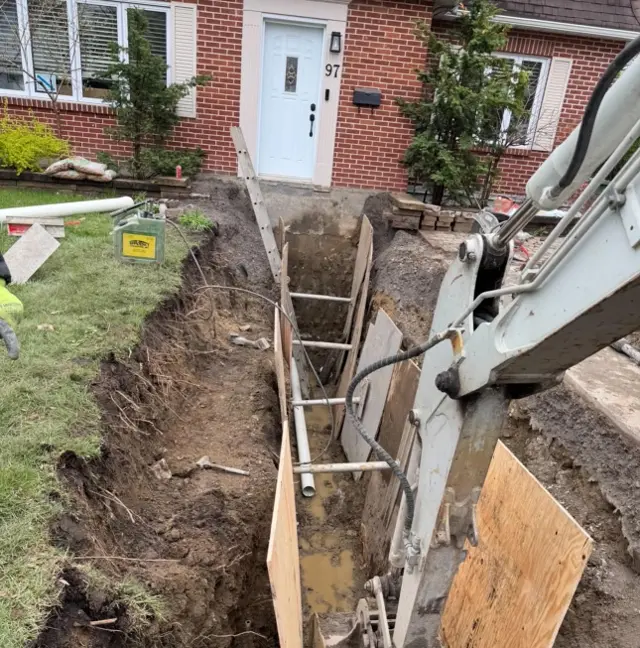 Tranchée étayée creusée devant une maison pour une entrée d’eau